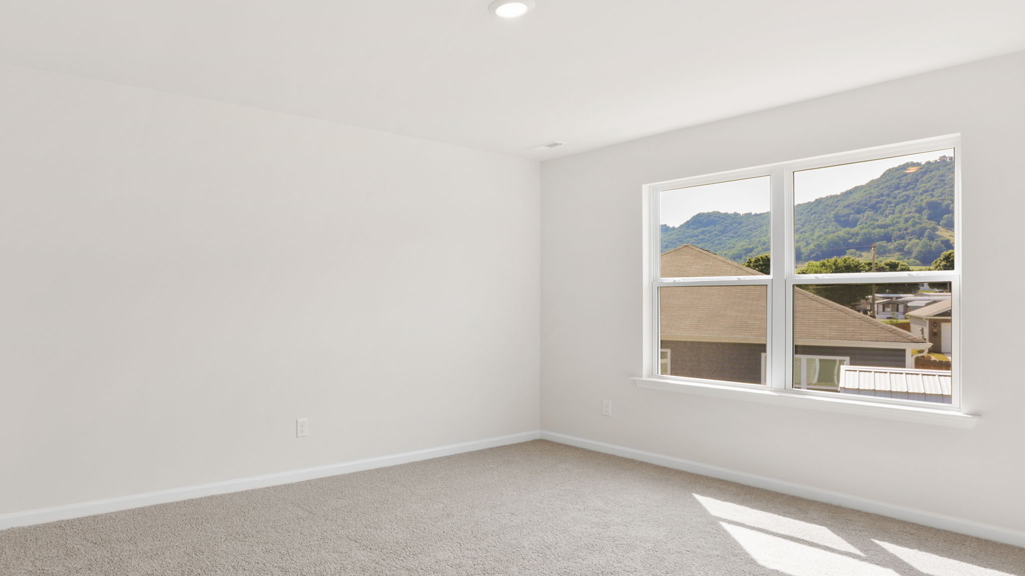 Carpeted bedroom with large windows