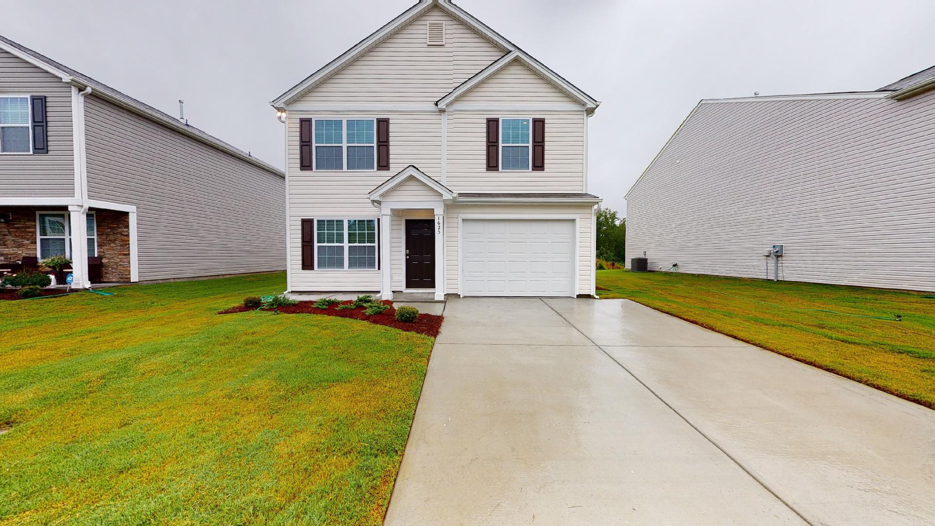 Two-story single family home with white vinyl