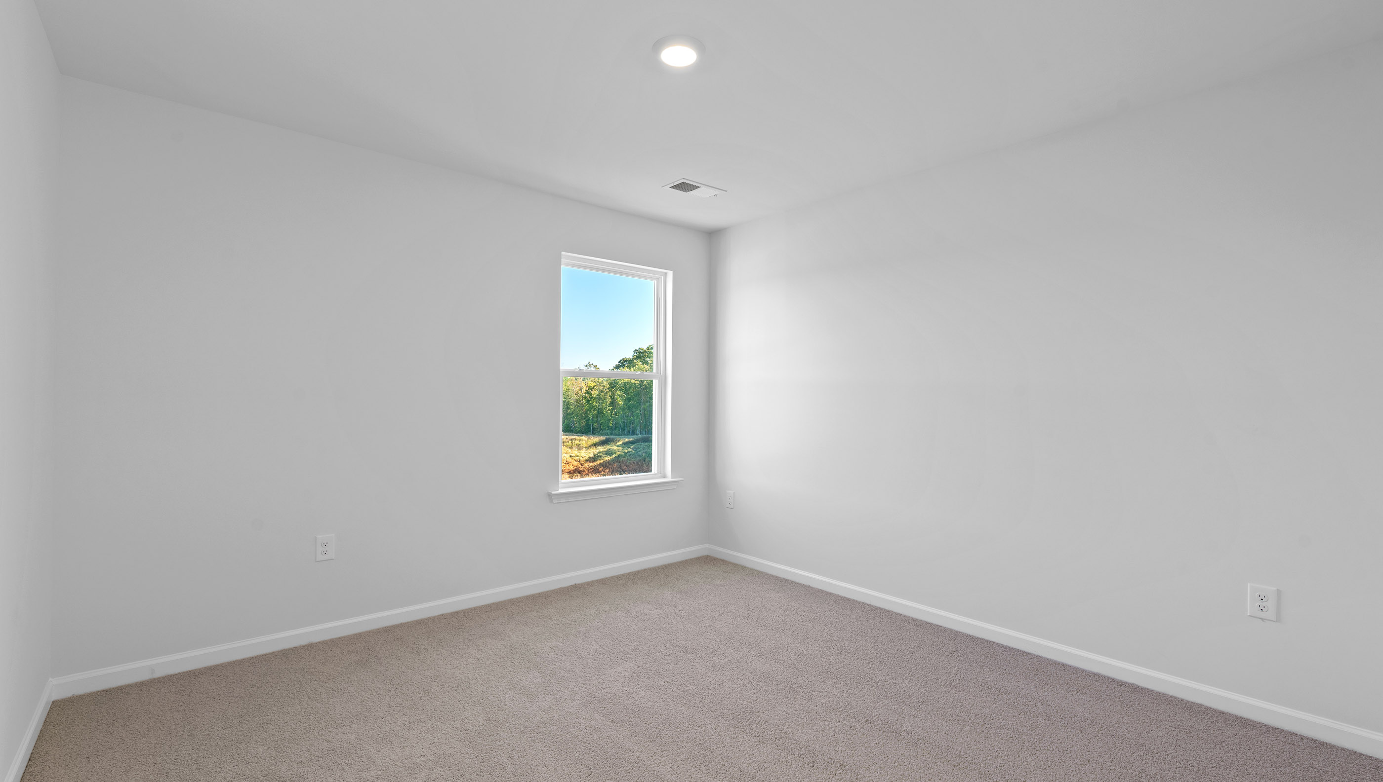 Carpeted bedroom with window