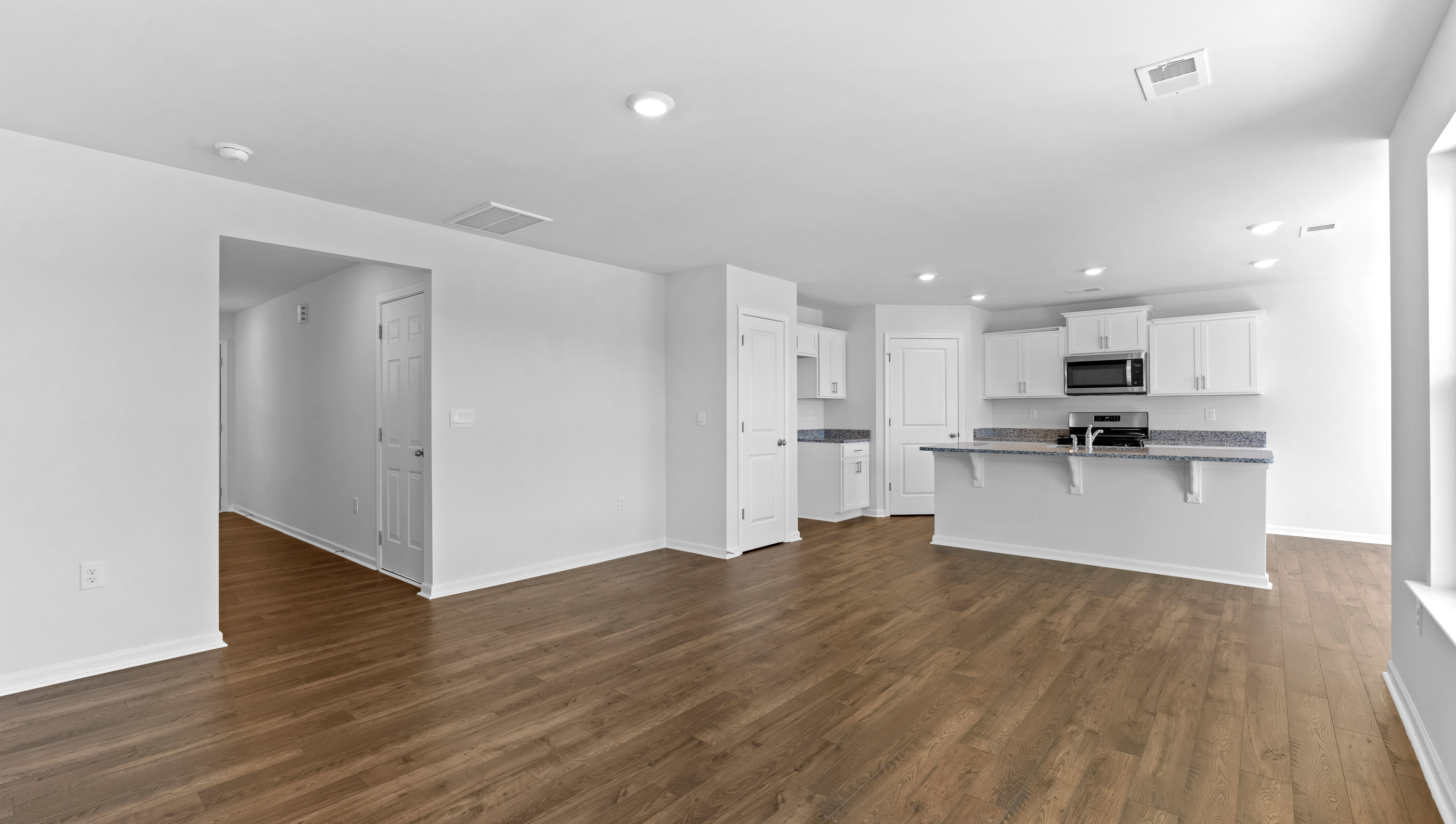 Open kitchen with stainless-steel appliances and island