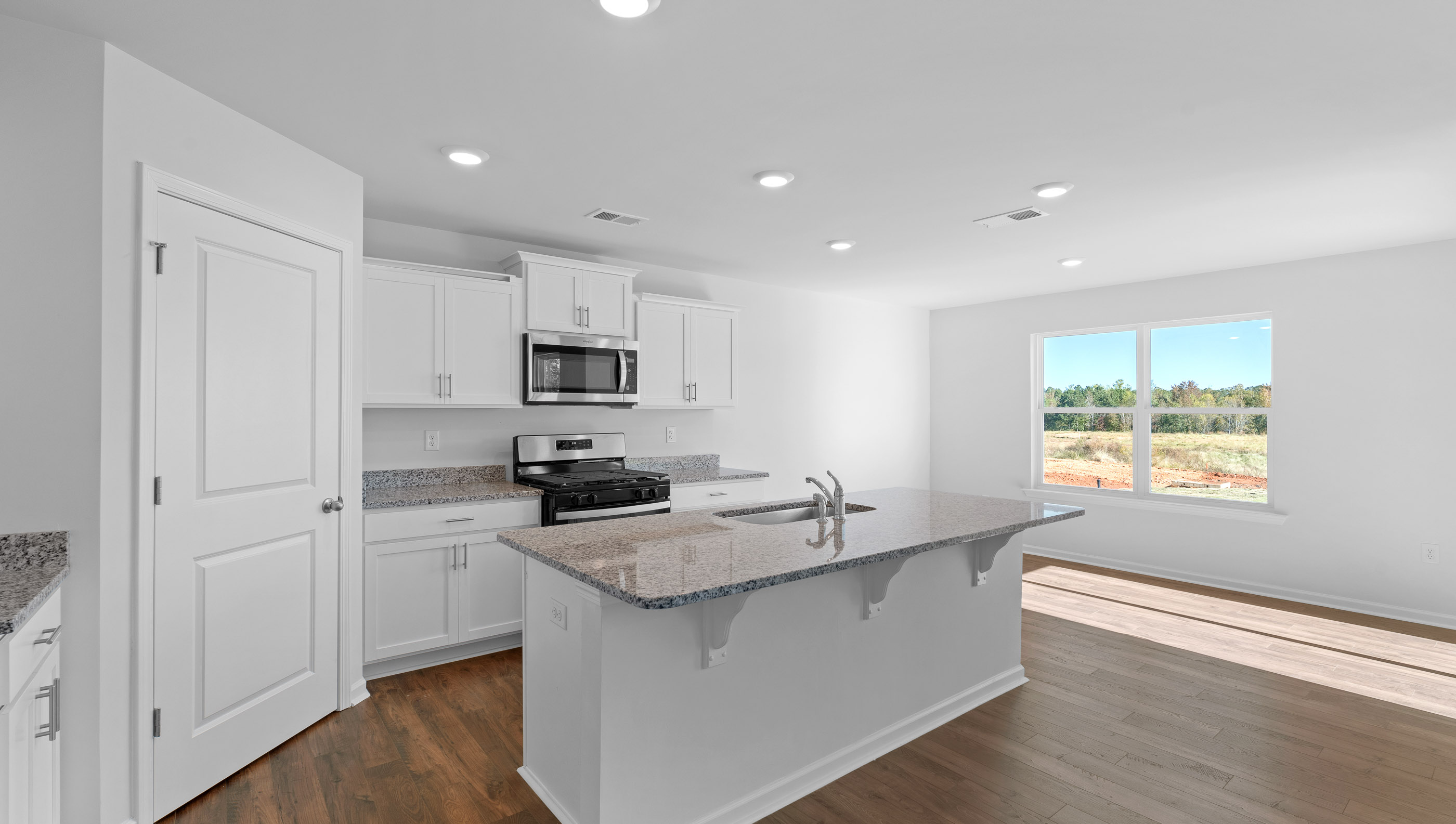 Open kitchen with stainless-steel appliances and island