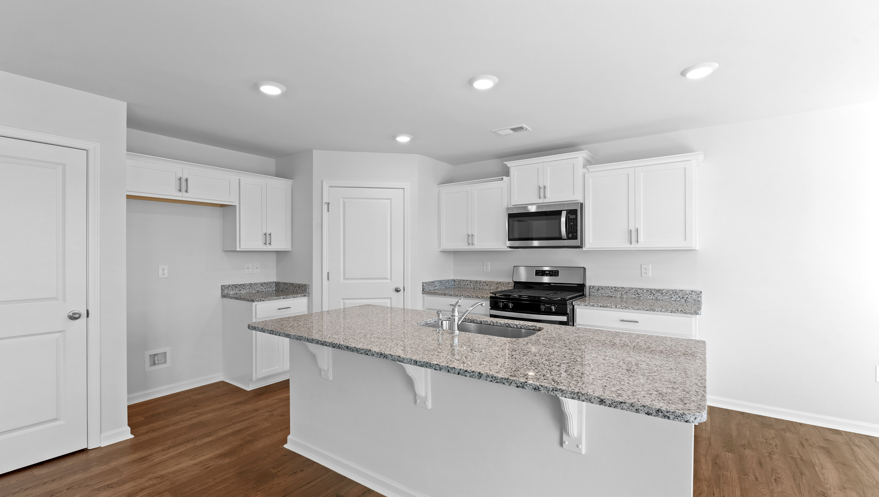 Open kitchen with stainless-steel appliances and island