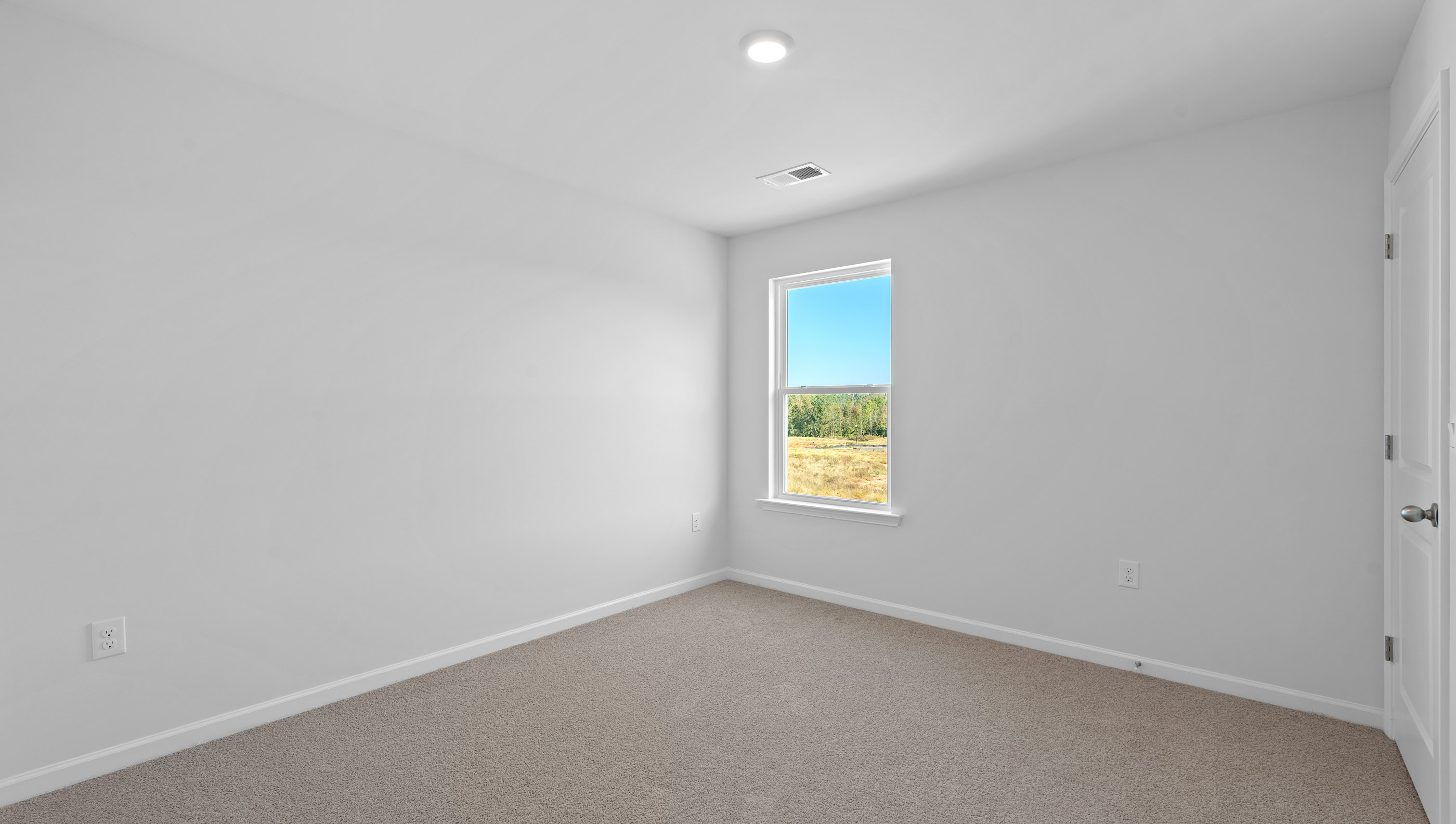 Carpeted bedroom with window