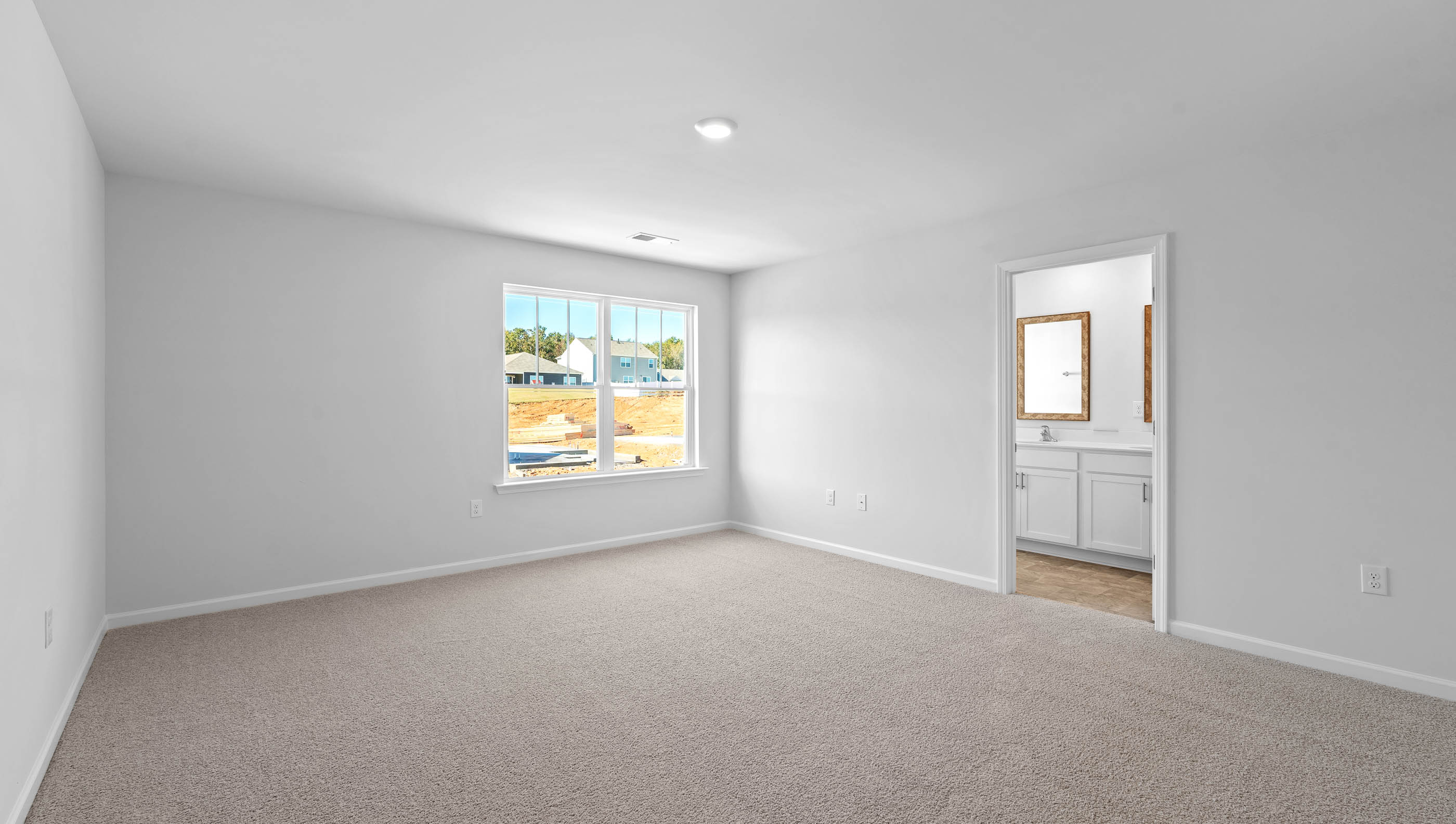Carpeted bedroom with window