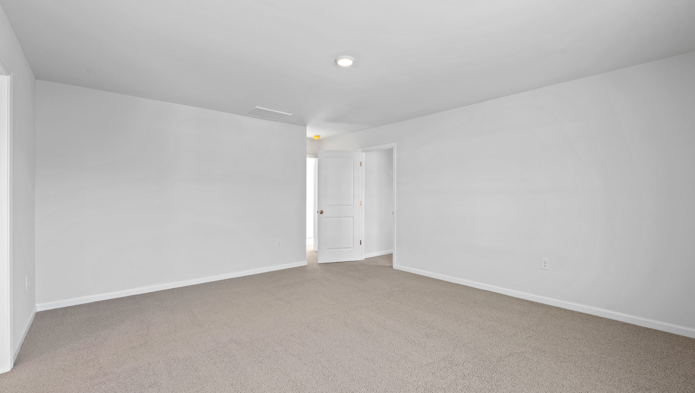 Carpeted bedroom with window