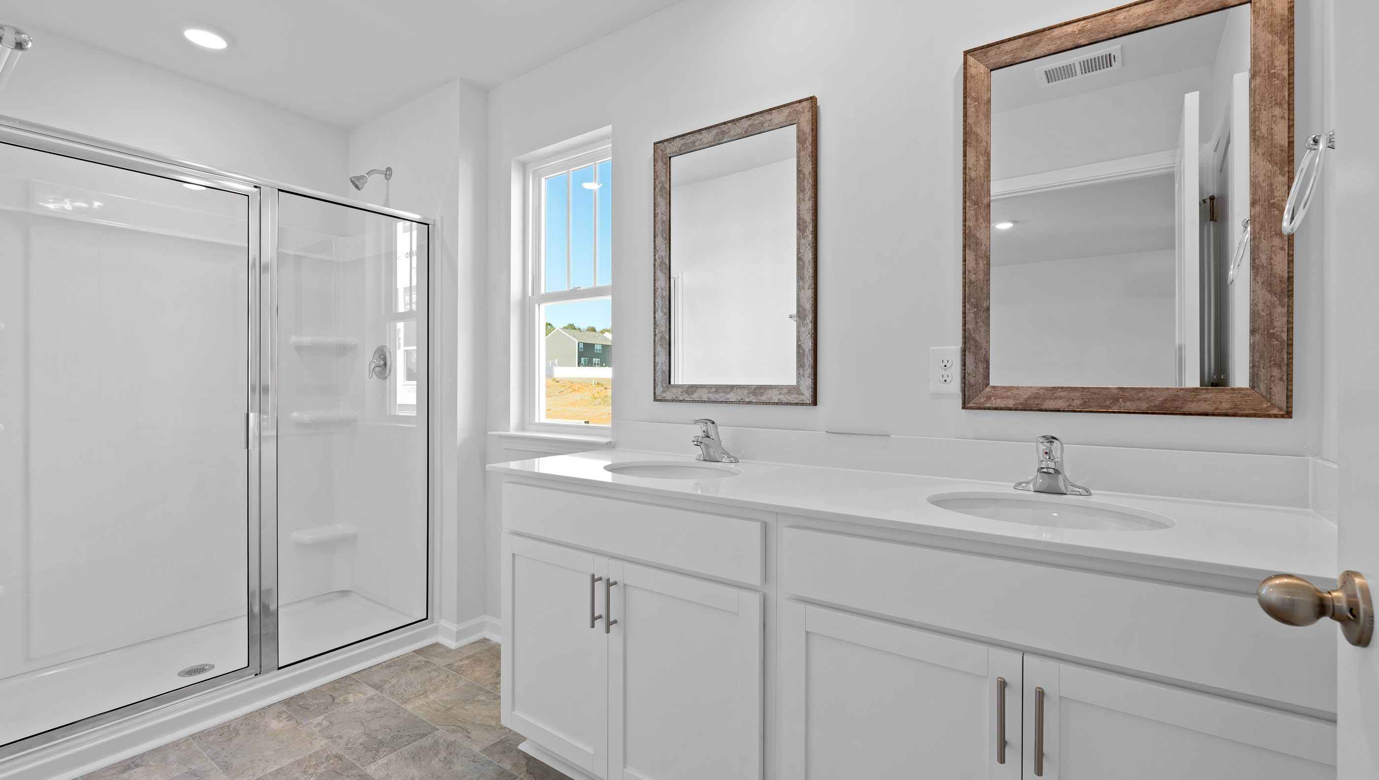 Bathroom with dual vanity and shower