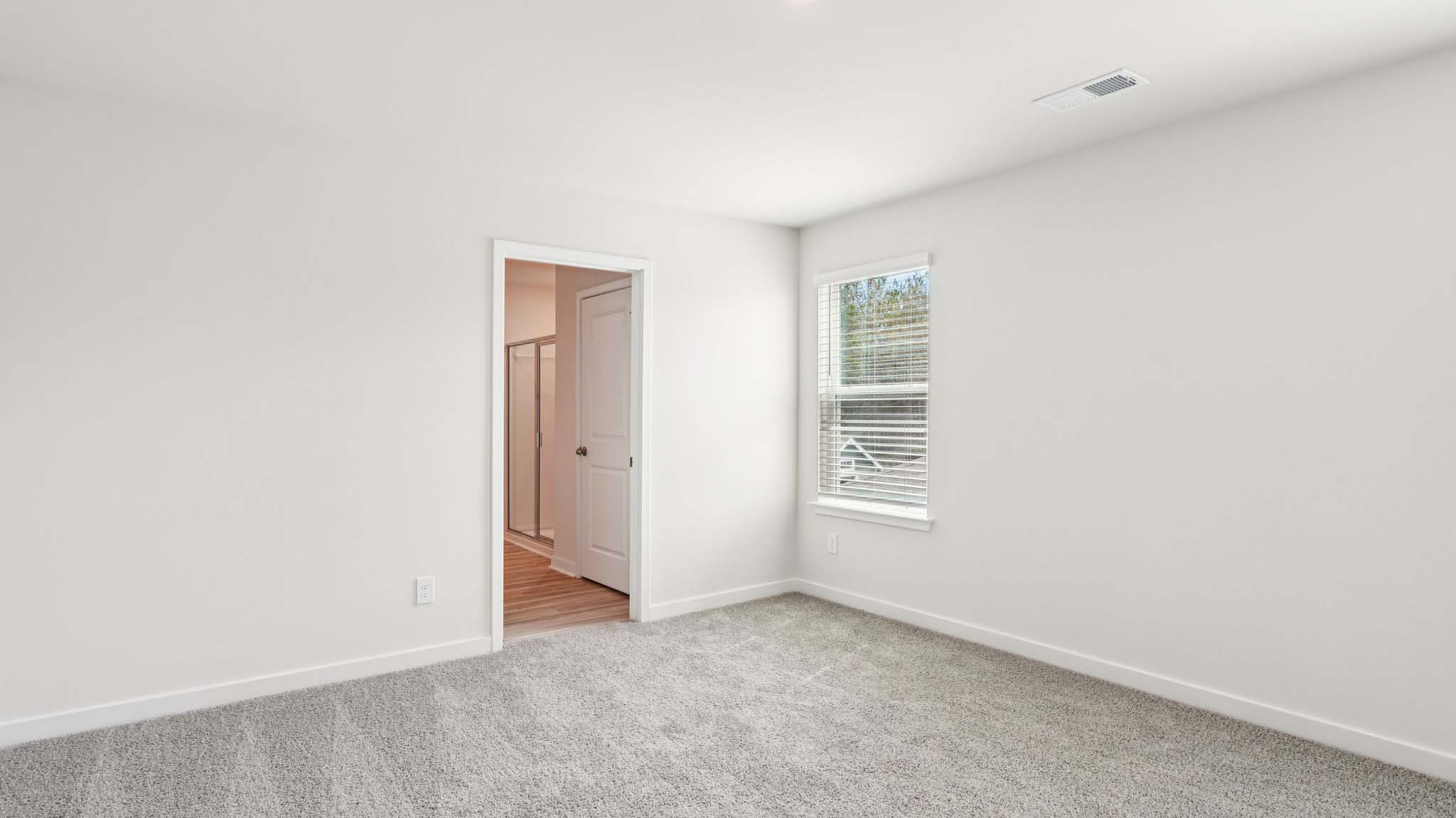 Primary bedroom with large window