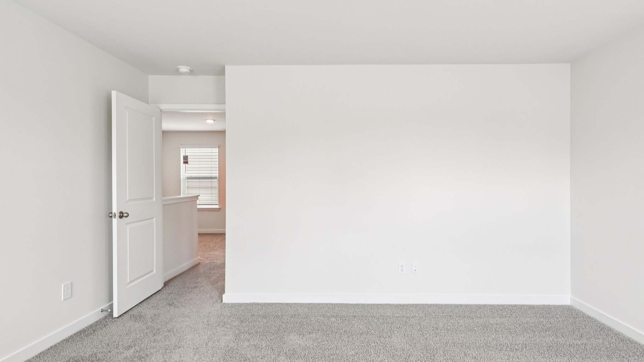 Primary bedroom with large window