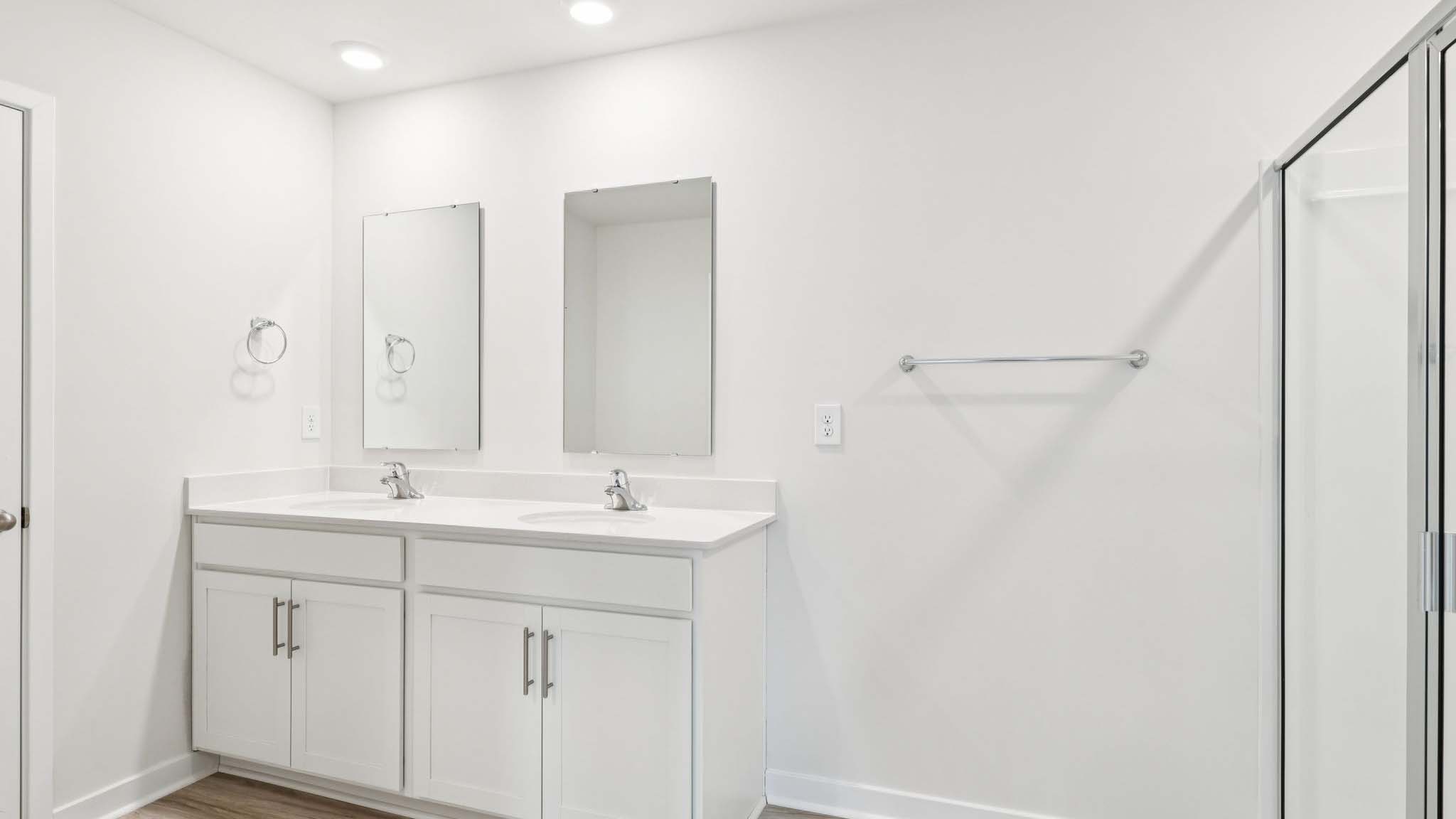 Primary bathroom with double vanity and shower