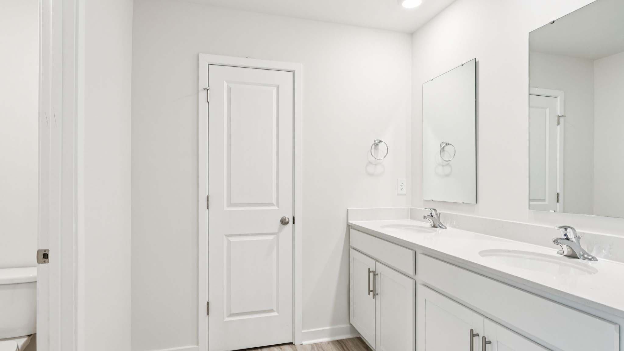 Primary bathroom with double vanity and shower