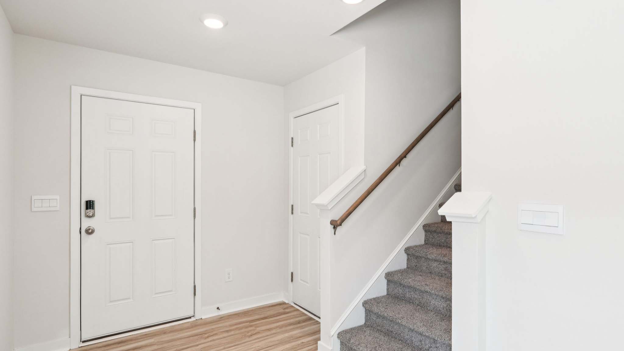 Foyer with stairs and front door