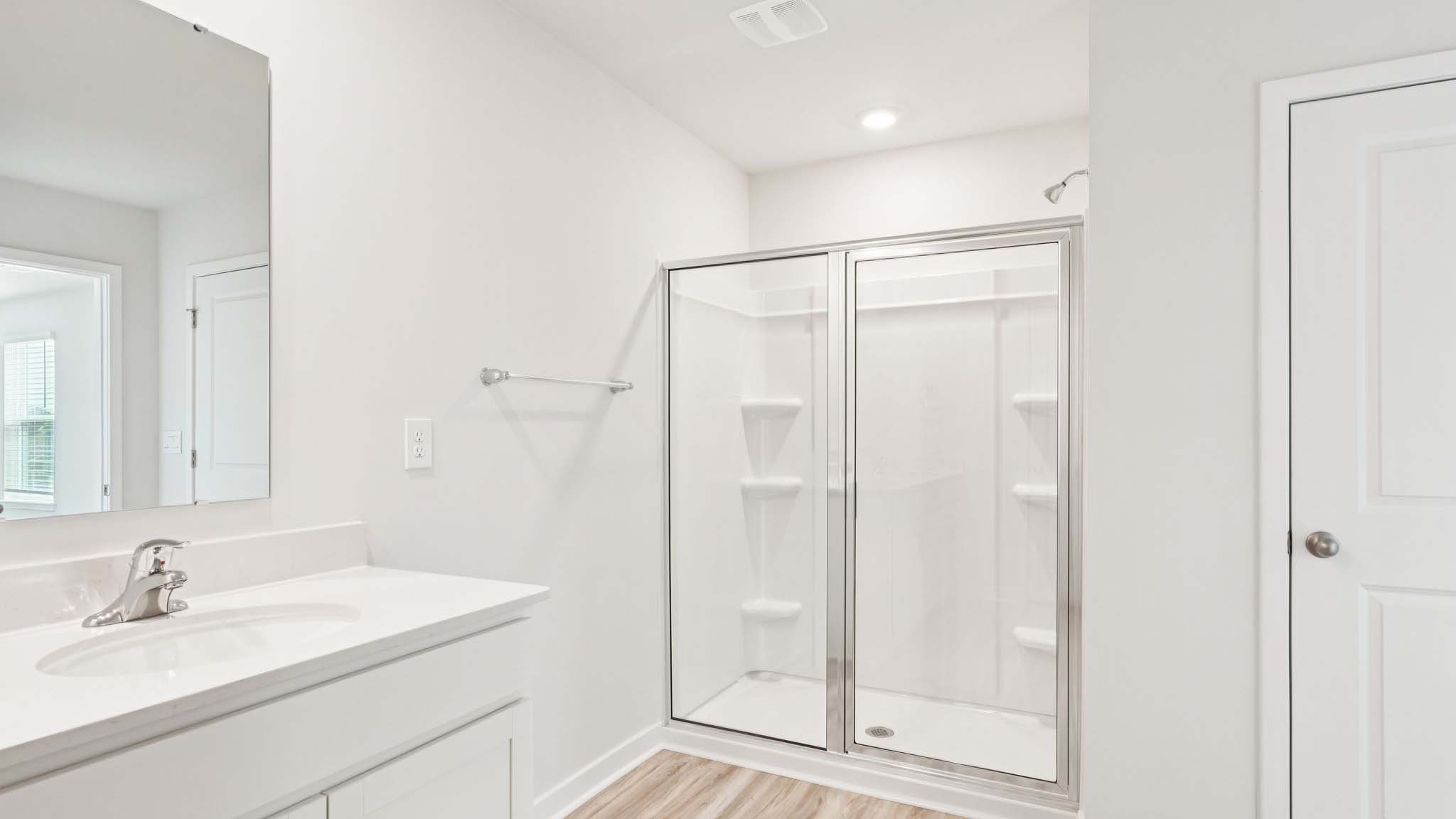 Primary bathroom with double vanity and shower