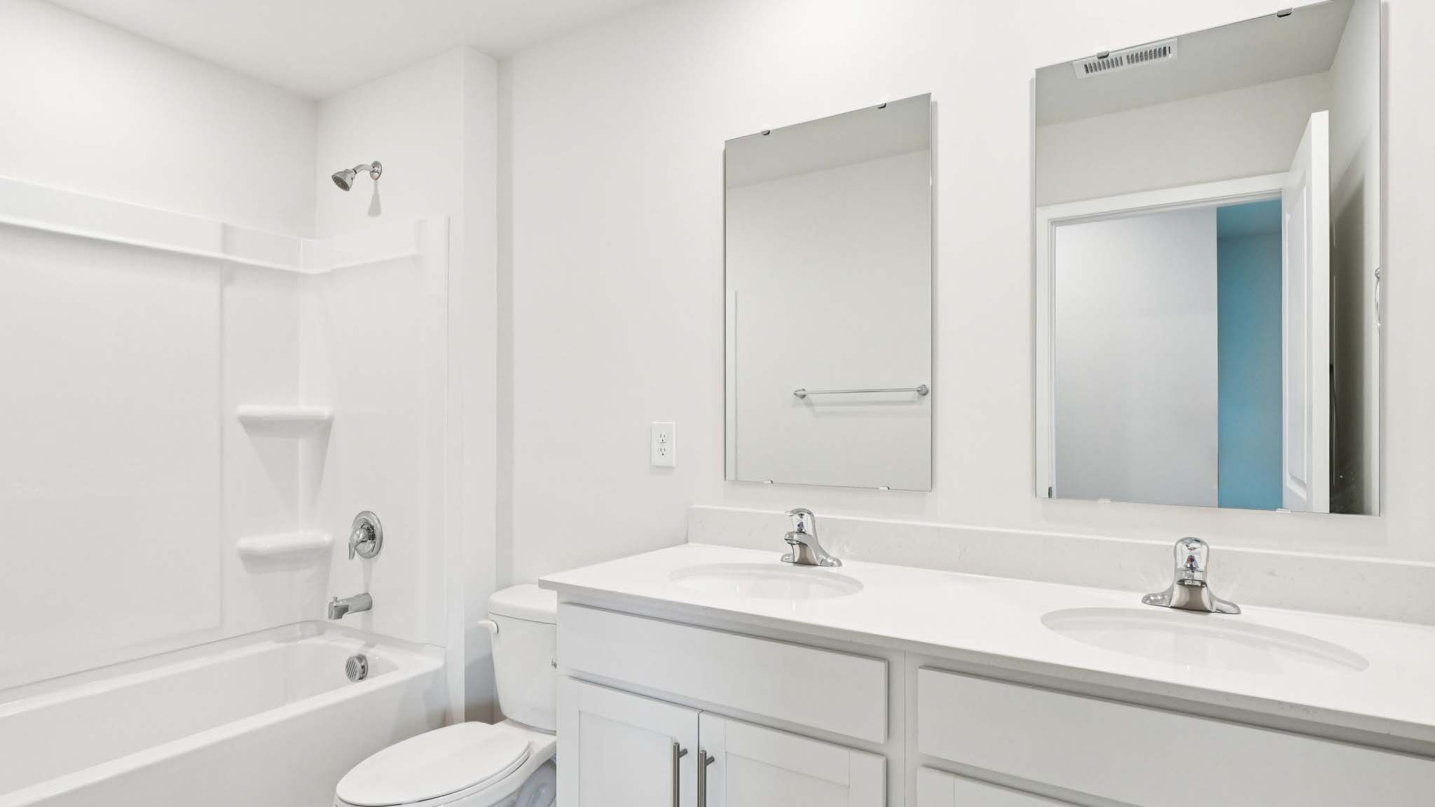 Bathroom with double vanity and tub
