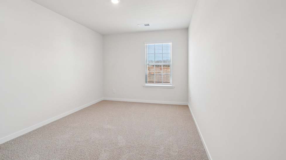 Carpeted bedroom with window