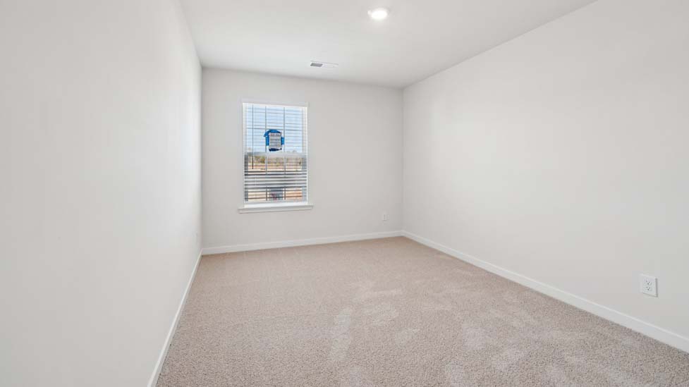 Carpeted bedroom with window