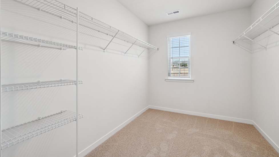 Primary walk in closet with window