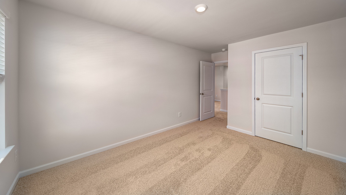 Carpeted bedroom with window