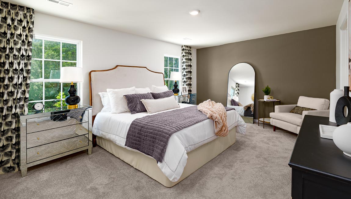 Primary bedroom with carpet, and large windows. New Home in Asheville, North Carolina