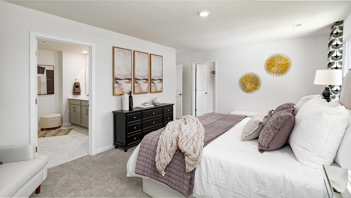 Primary bedroom with carpet, and large windows. New Home in Asheville, North Carolina