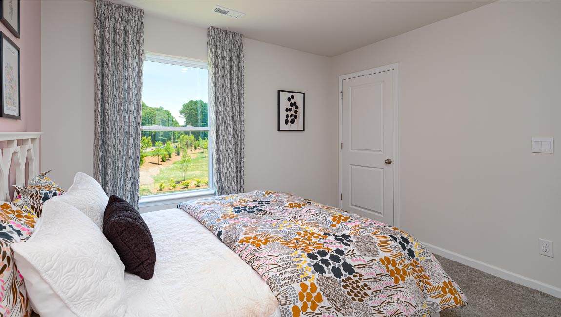 Carpeted bedroom with small window