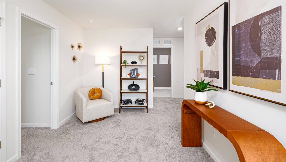 Upstairs carpeted loft with small window