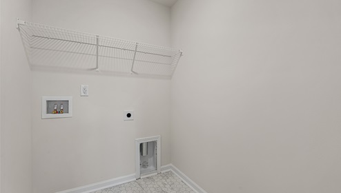 Laundry Room with built in storage racks above machine space