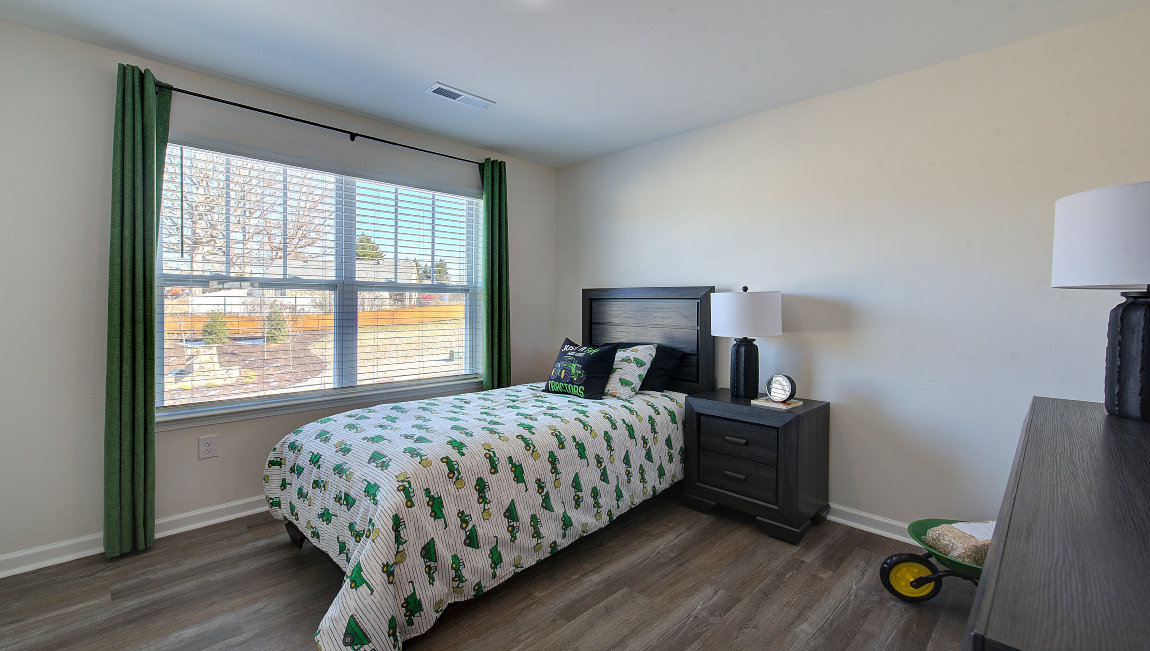 Carpeted bedroom with large window