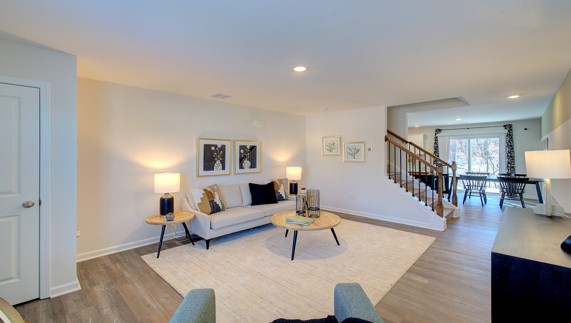 Living room by entryway with vinyl flooring and large window. New Homes in Asheville, North Carolina