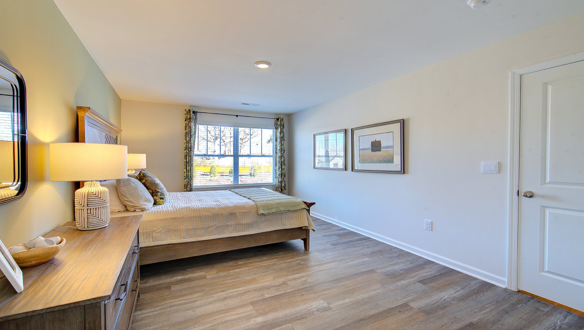 Carpeted bedroom with large window