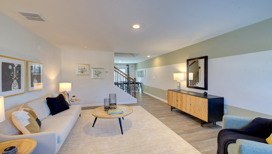 Living room by entryway with vinyl flooring and large window. New Homes in Asheville, North Carolina