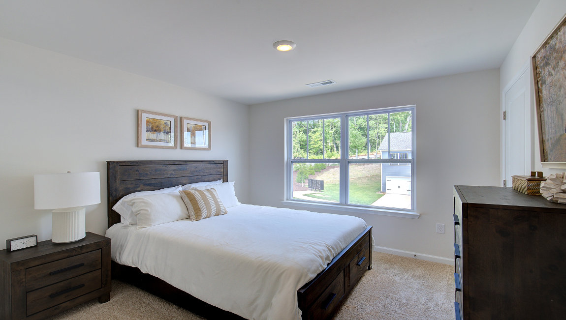 Carpeted bedroom with large window