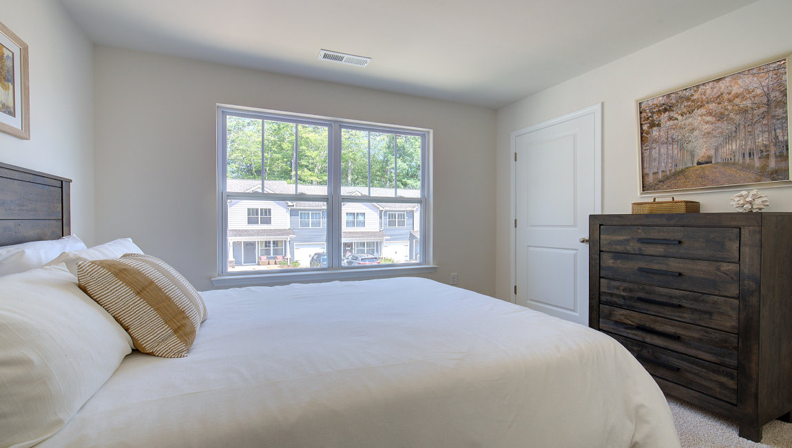 Carpeted bedroom with large window