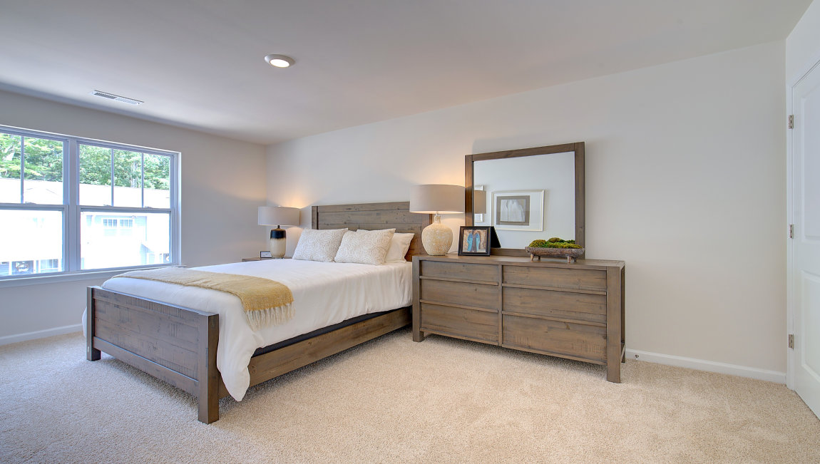 Carpeted bedroom with large window