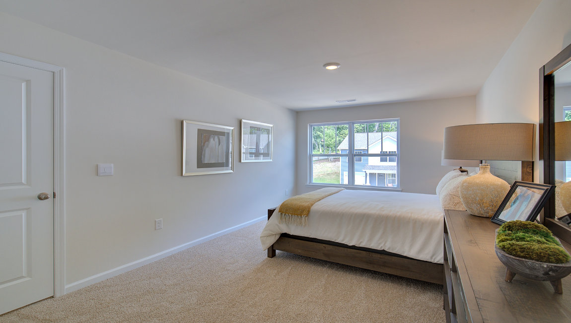 Carpeted bedroom with large window