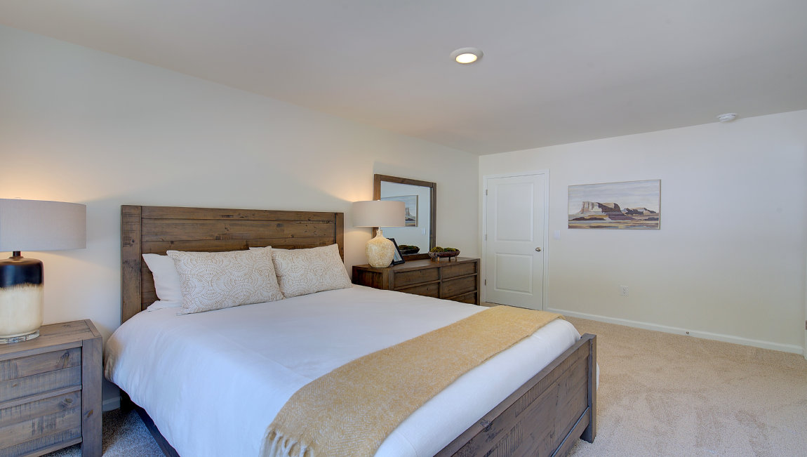 Carpeted bedroom with large window