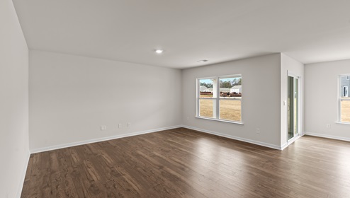 Family room with wood floors and windows
