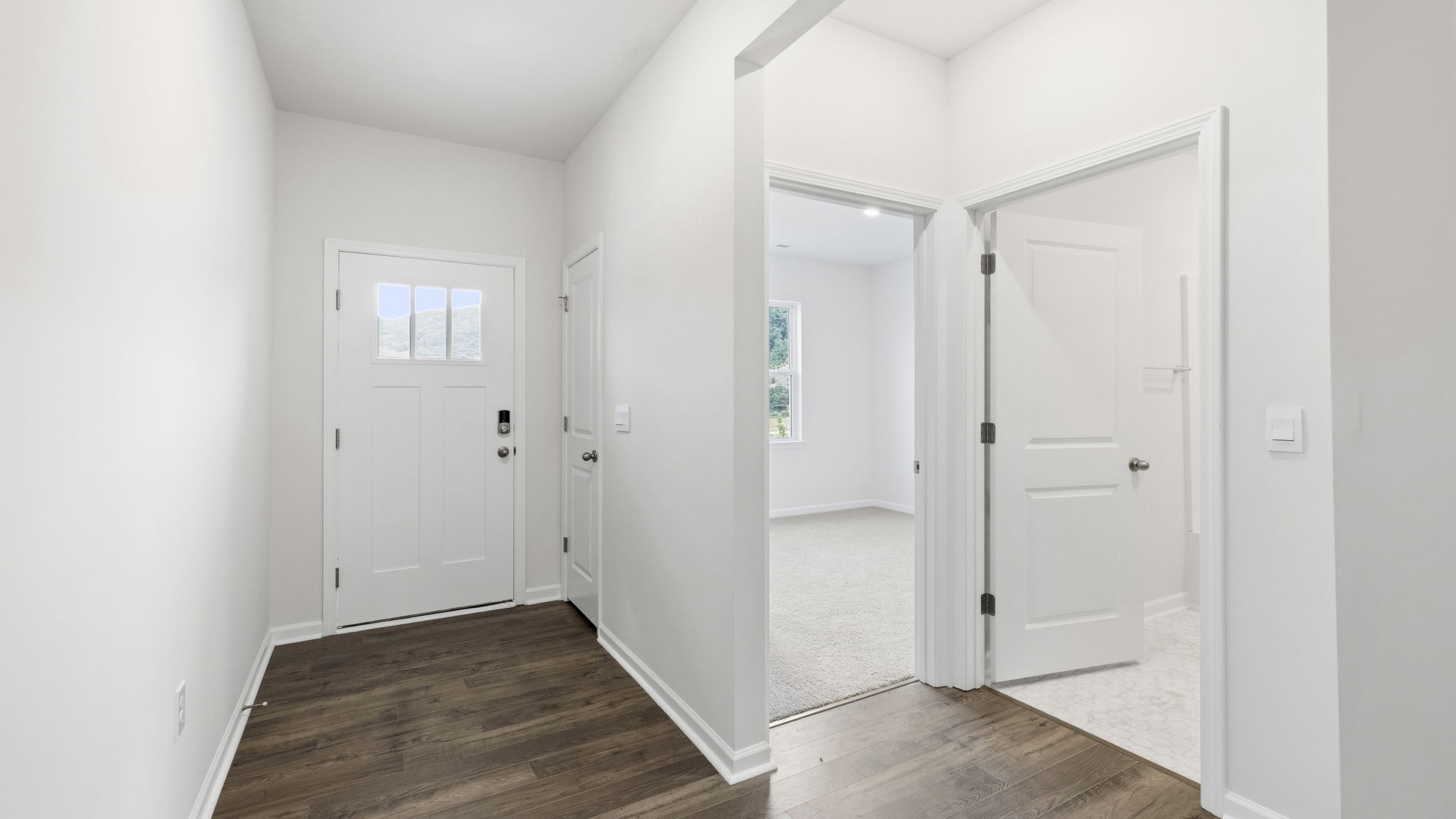 Welcoming foyer with views into bathroom and bedroom