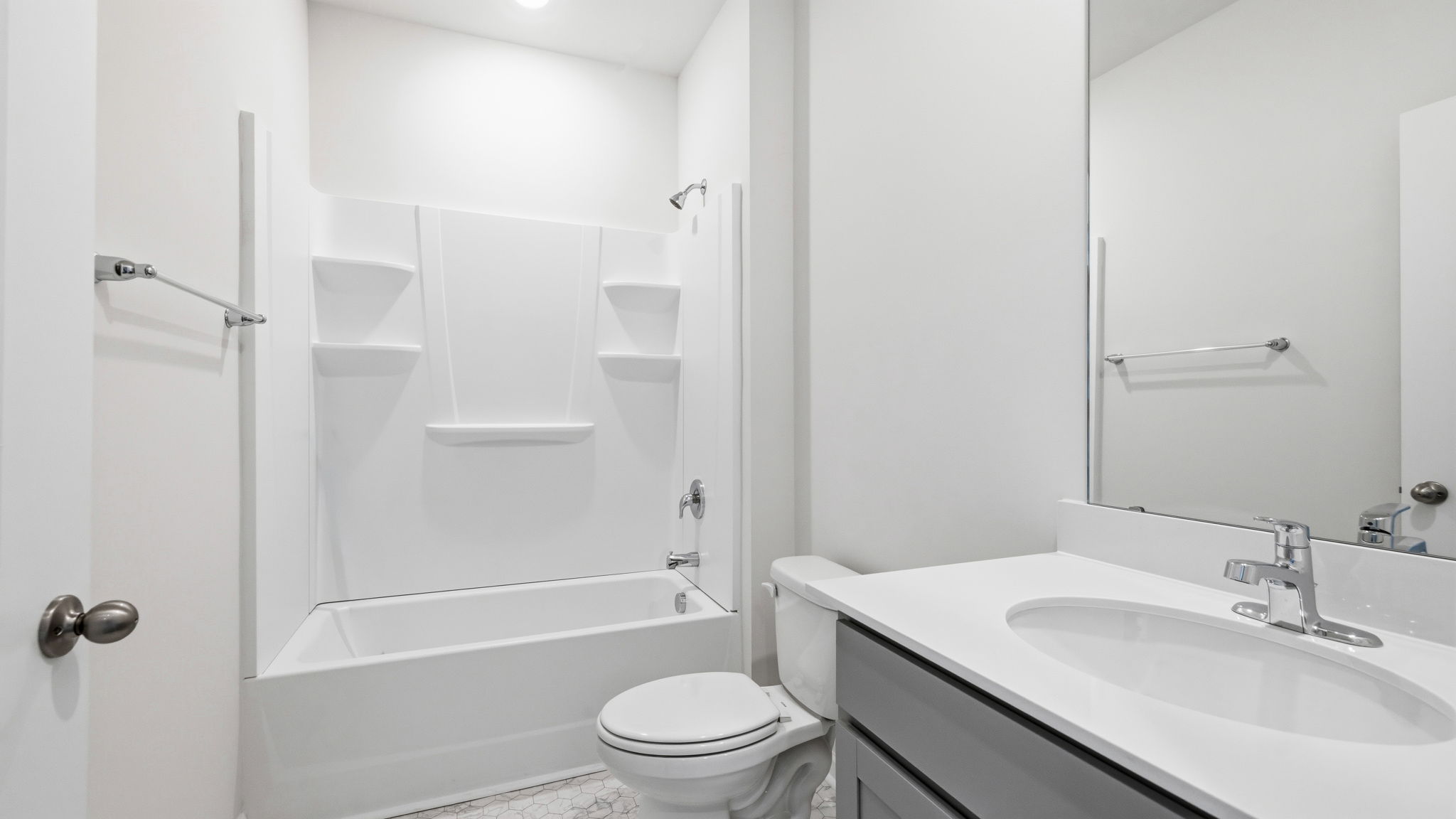 Bathroom with white countertop and bathtub