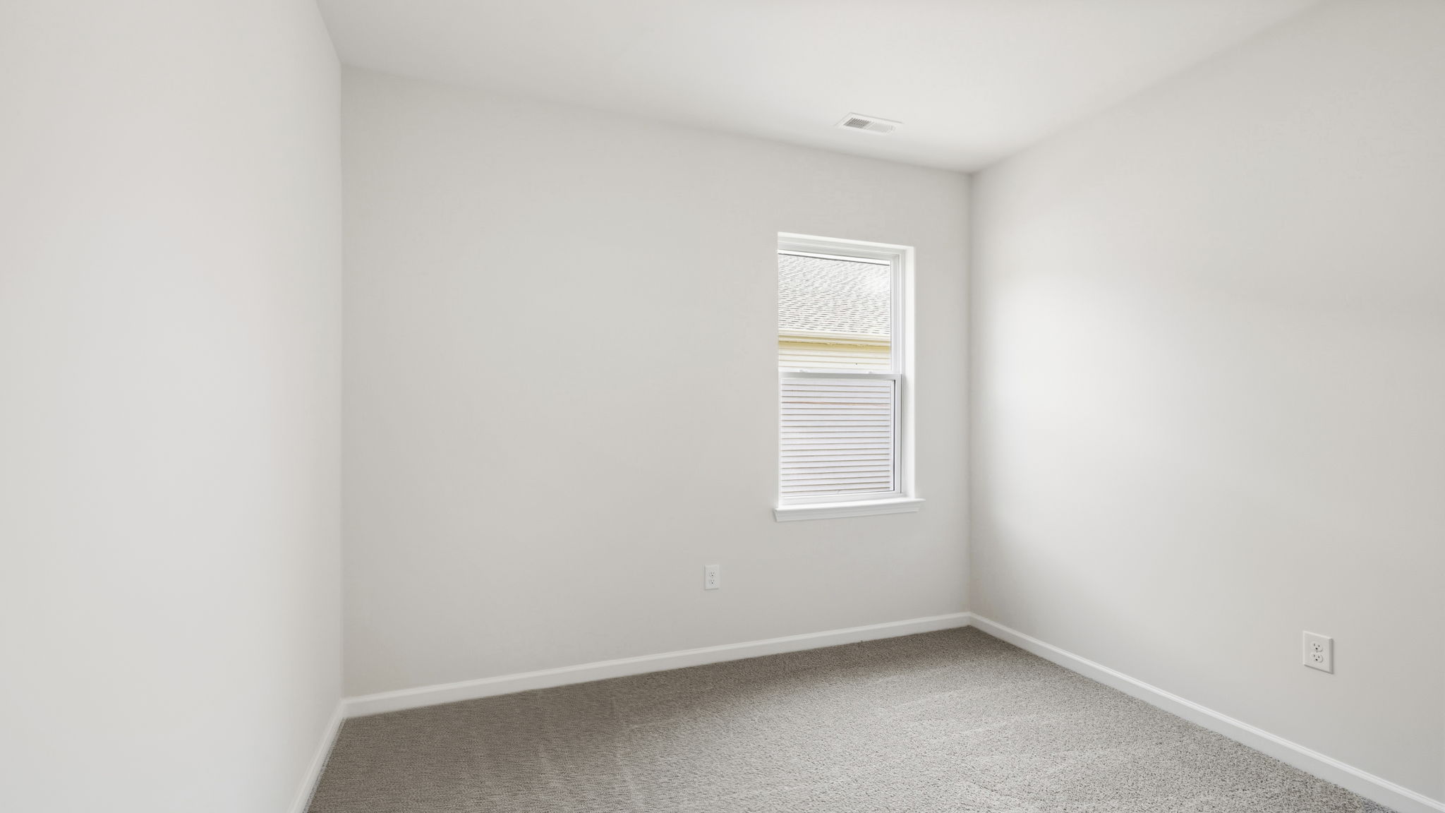 Carpeted bedroom with large window