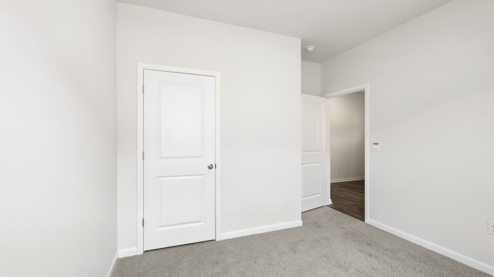Carpeted bedroom with large window