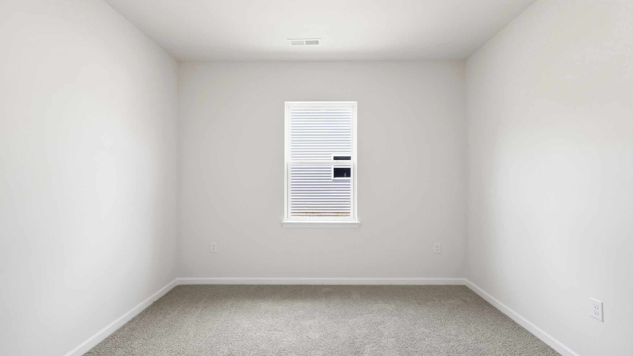 Carpeted bedroom with large window