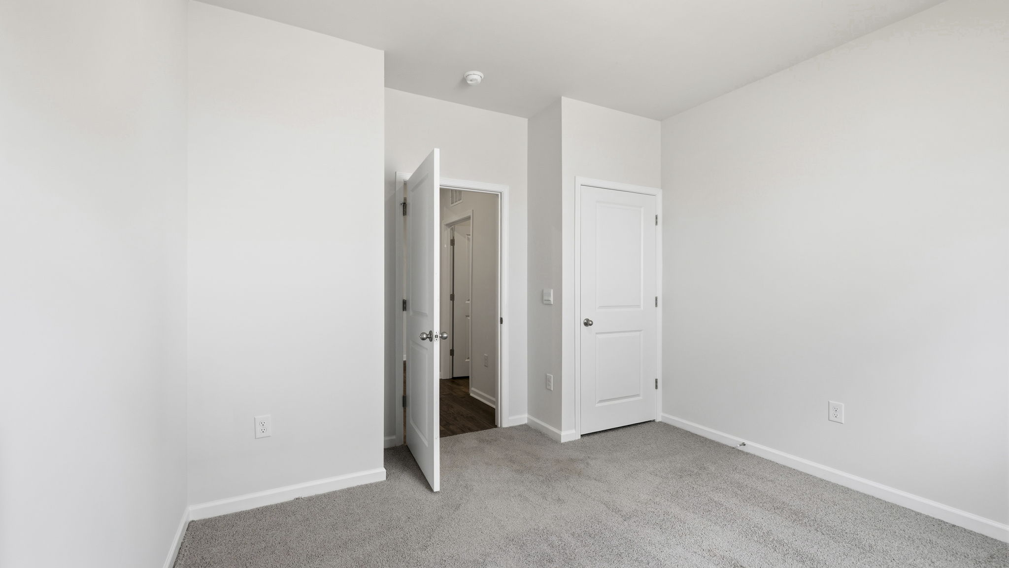 Carpeted bedroom with large window