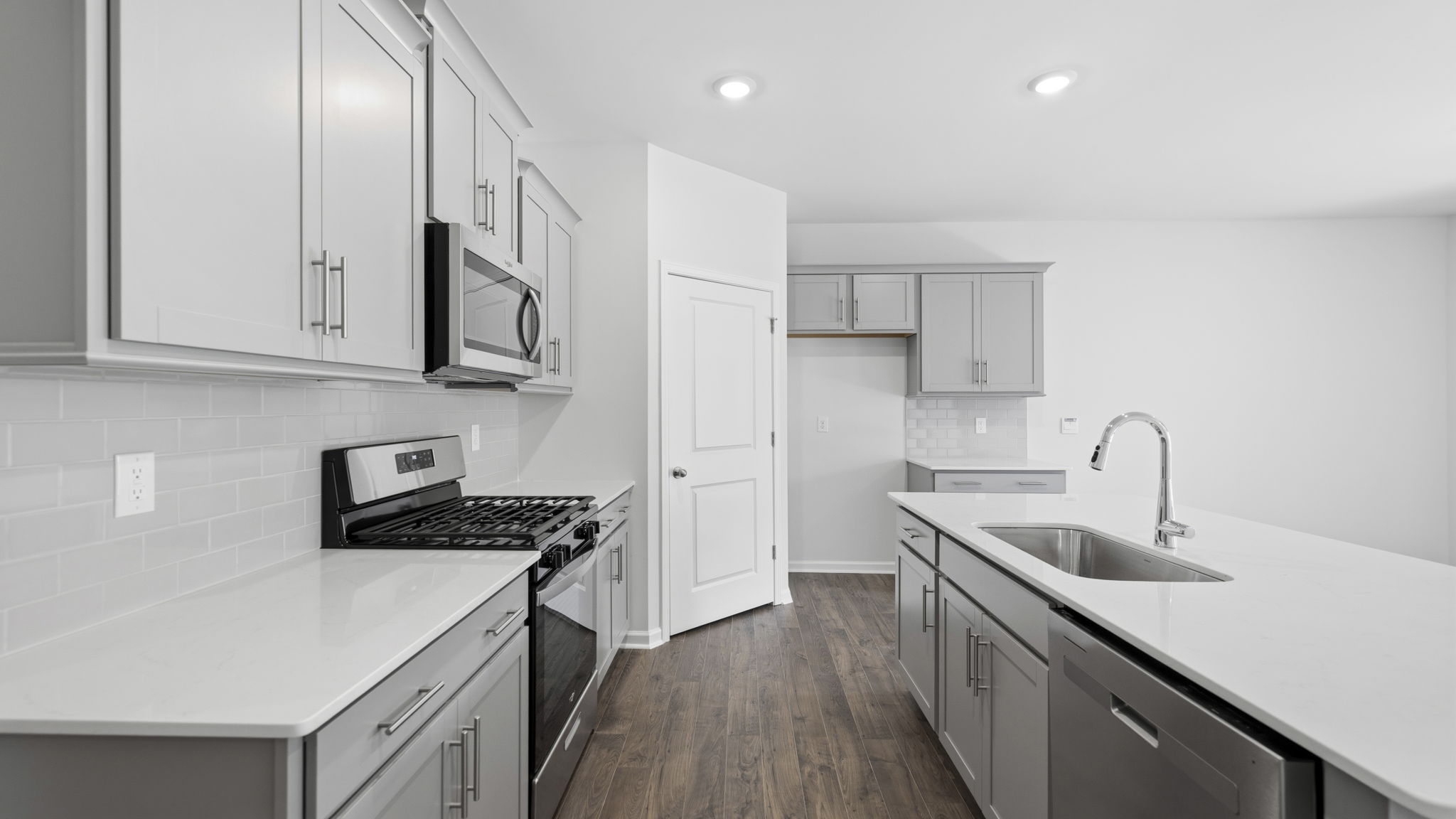 Open concept kitchen with island and stainless steel appliances