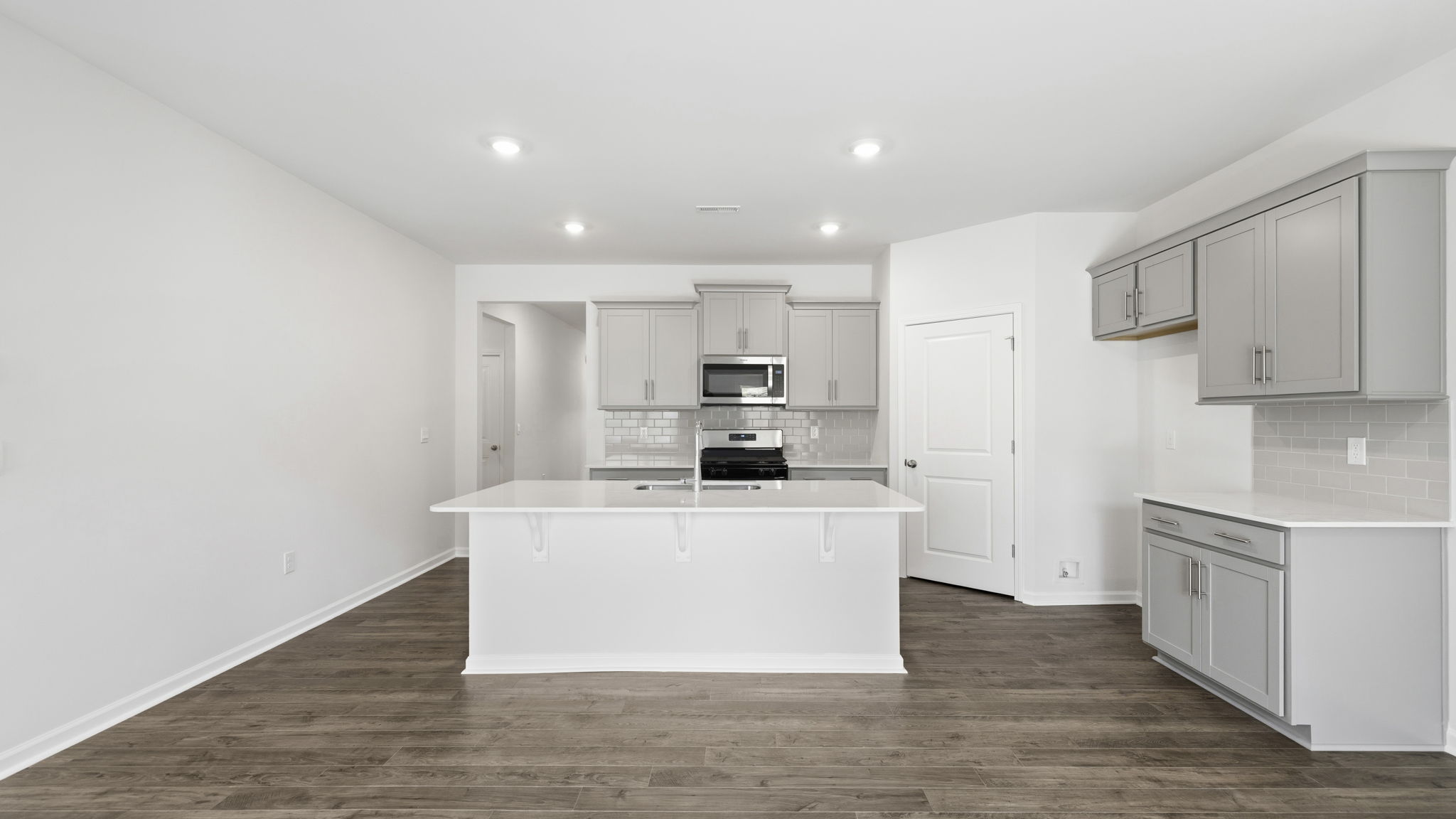 Open concept kitchen with island and stainless steel appliances