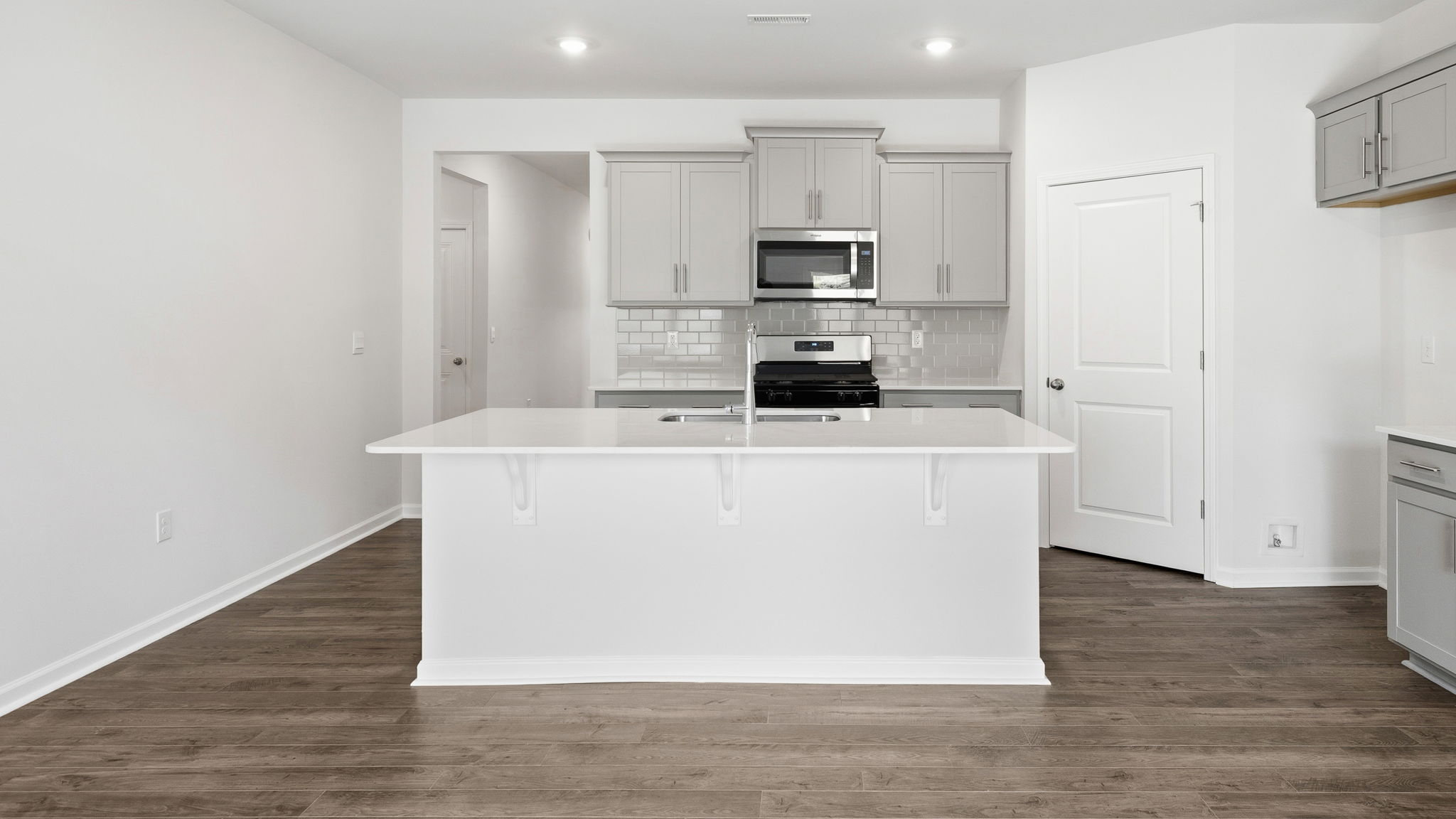 Open concept kitchen with island and stainless steel appliances