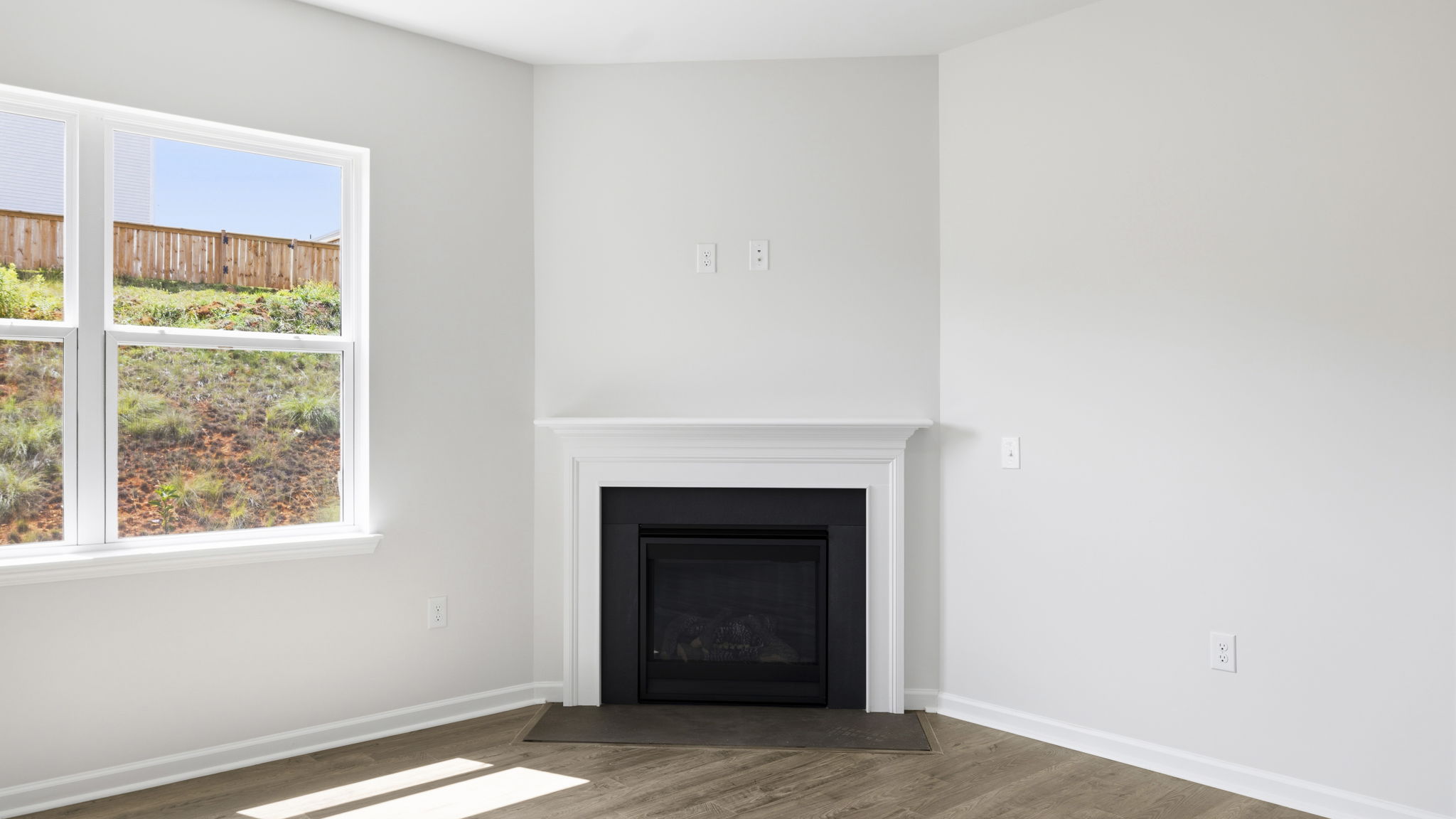 Living area with gas fireplace and large window