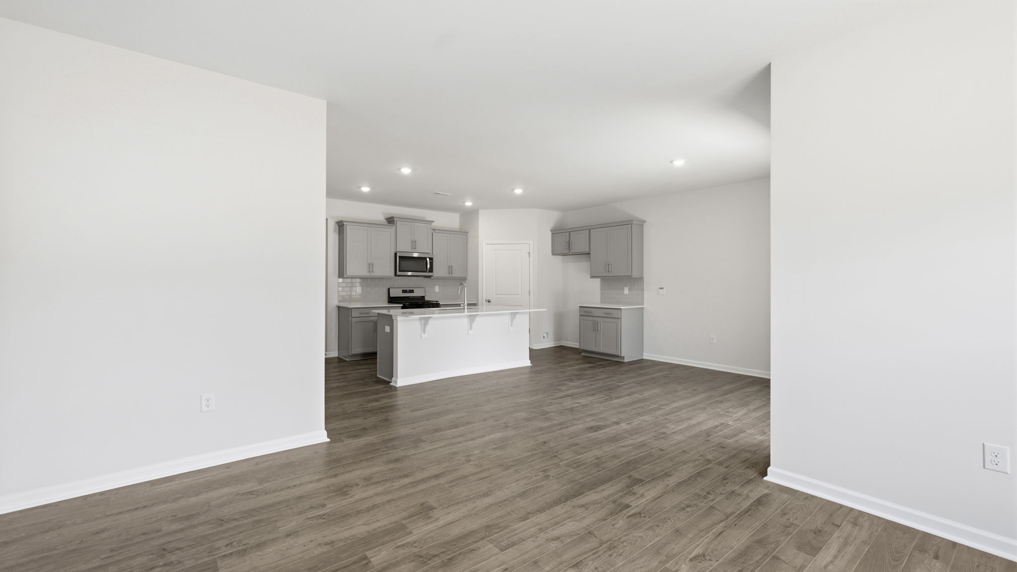 Open living area with view of kitchen with large island