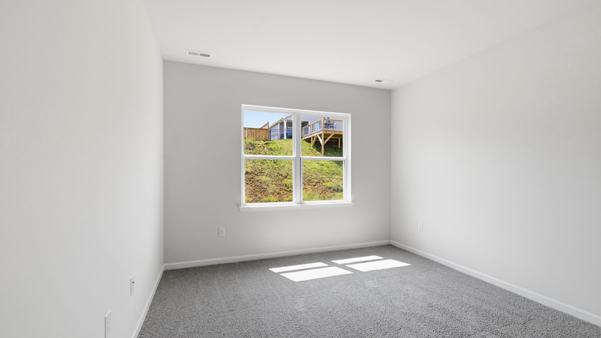 Carpeted bedroom with large window