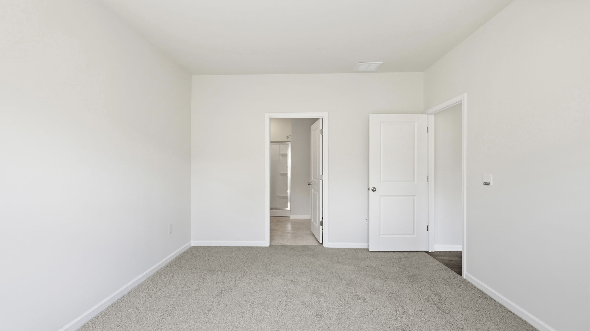Carpeted bedroom with large window