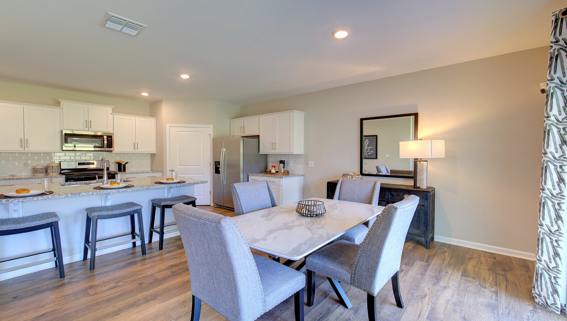 Dining area with wood floors and sliding glass back door